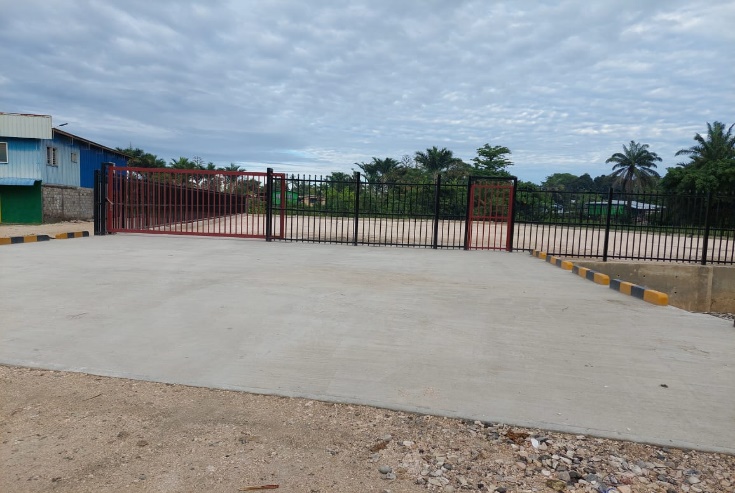 New concrete market surface and red perimeter fence at Malu'u